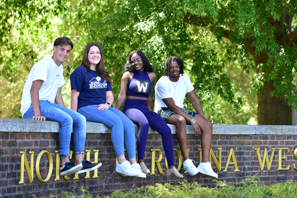 college kids sitting on wall