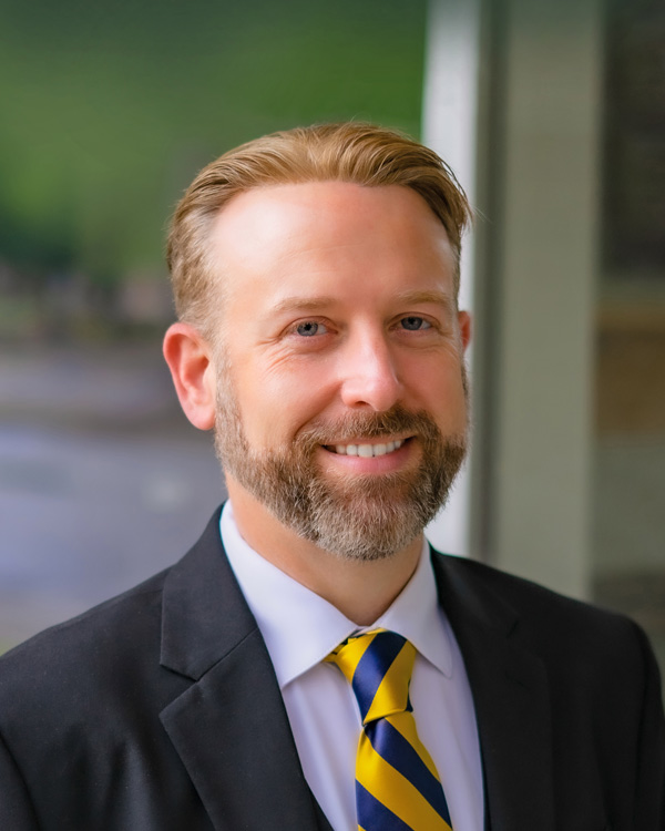 white male professional in navy suit